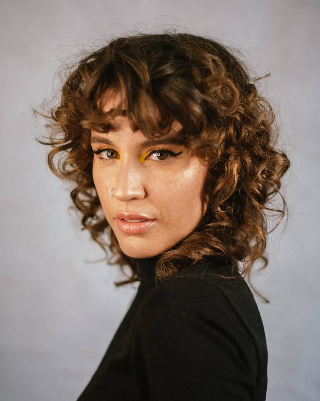 26. Shaggy Curly Hair with Undone Bangs