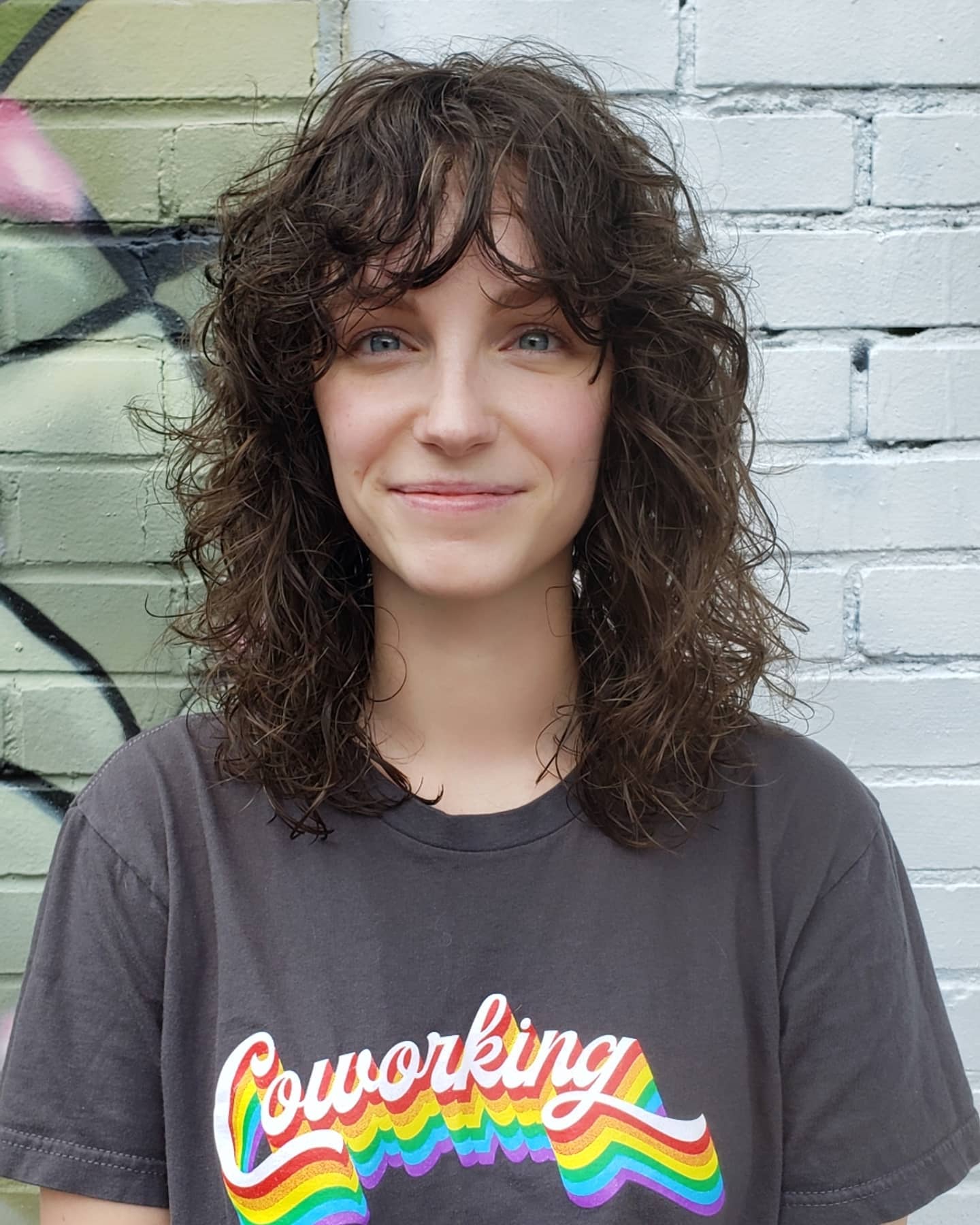 21. Shaggy Curly Haircut with Soft Bangs