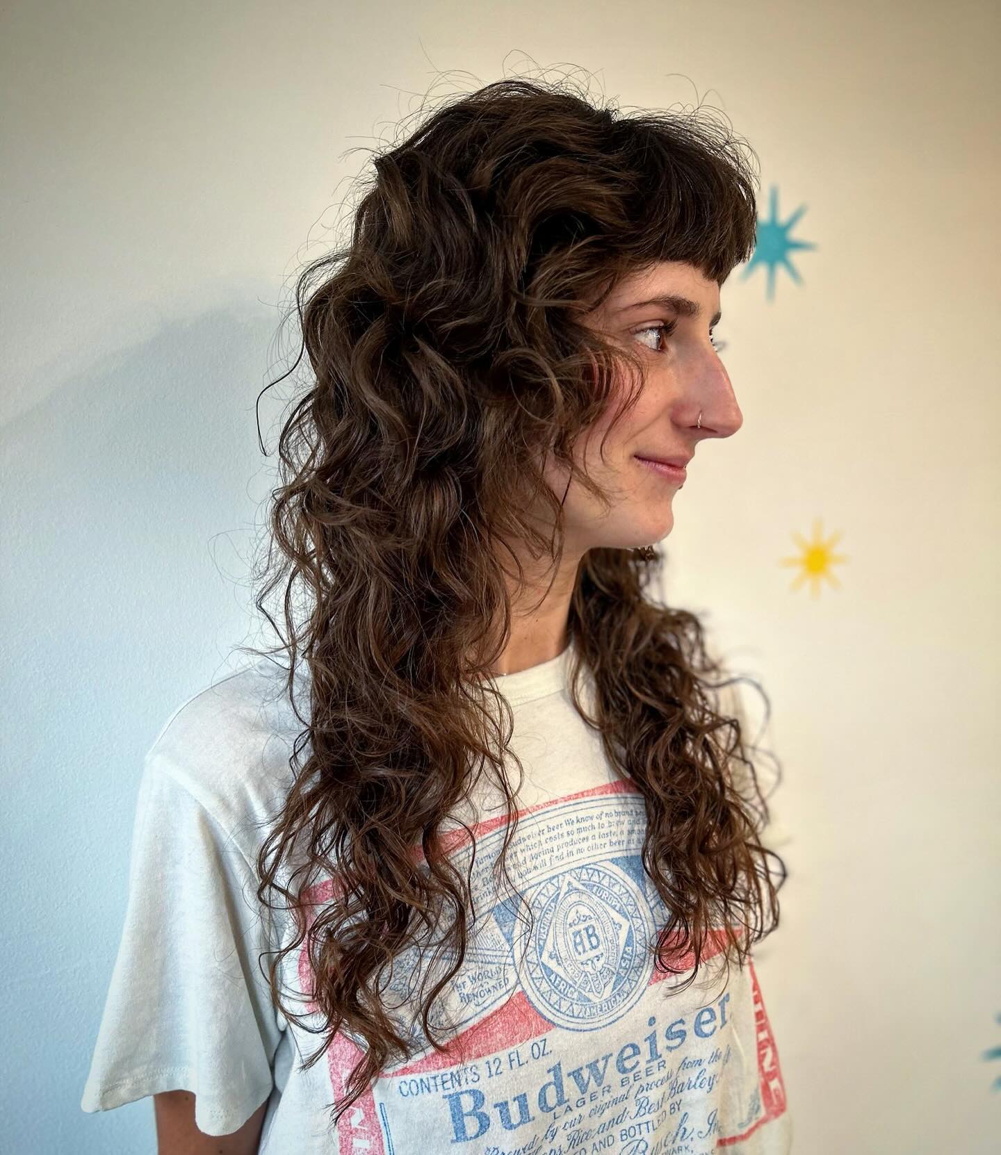 3. Shaggy Curly Haircut with Bangs