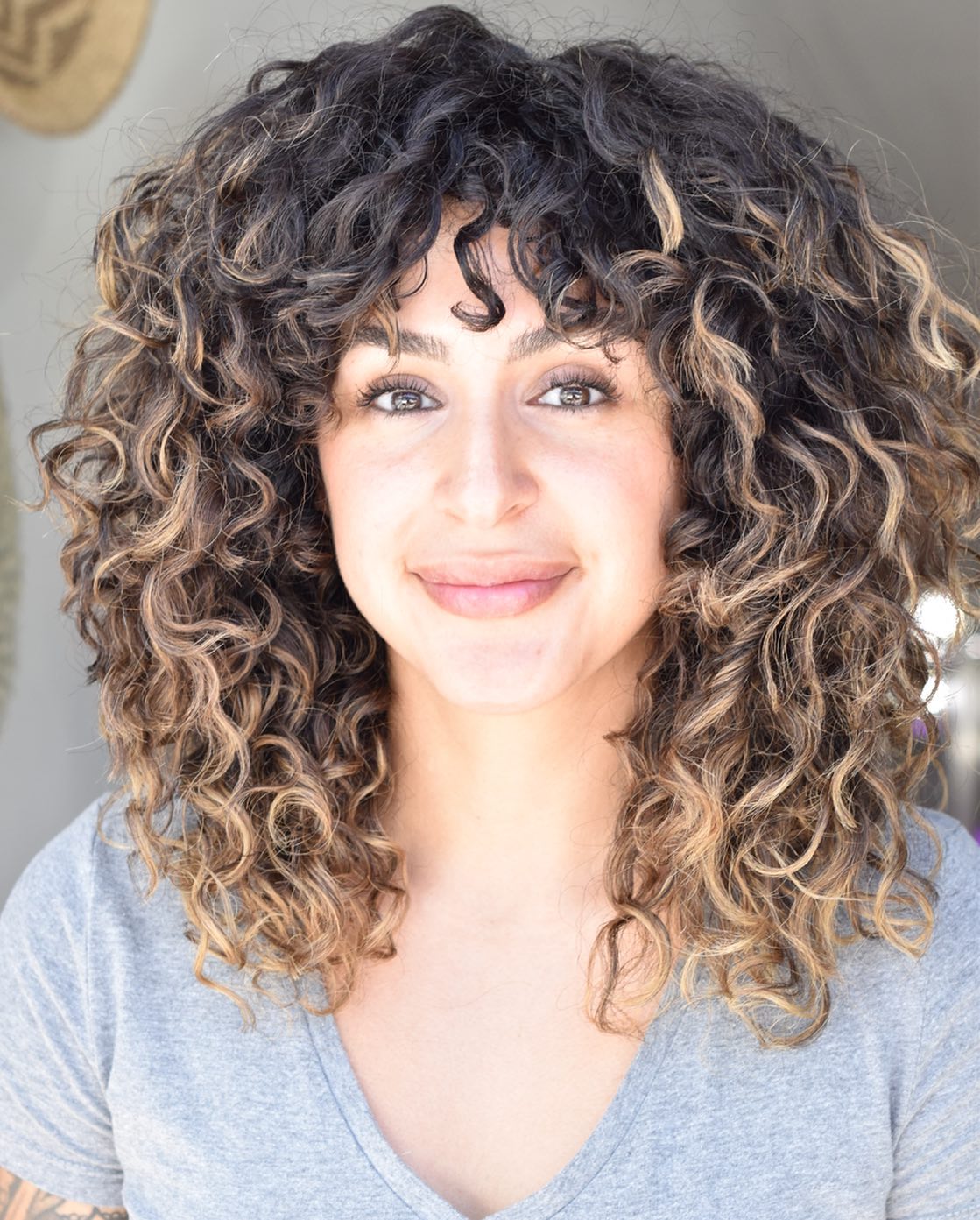 22. Shaggy Curly Hairstyle with Highlights